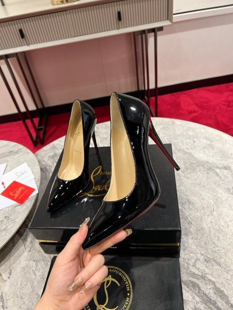 Black patent pump held to show the side profile — supplier photo
